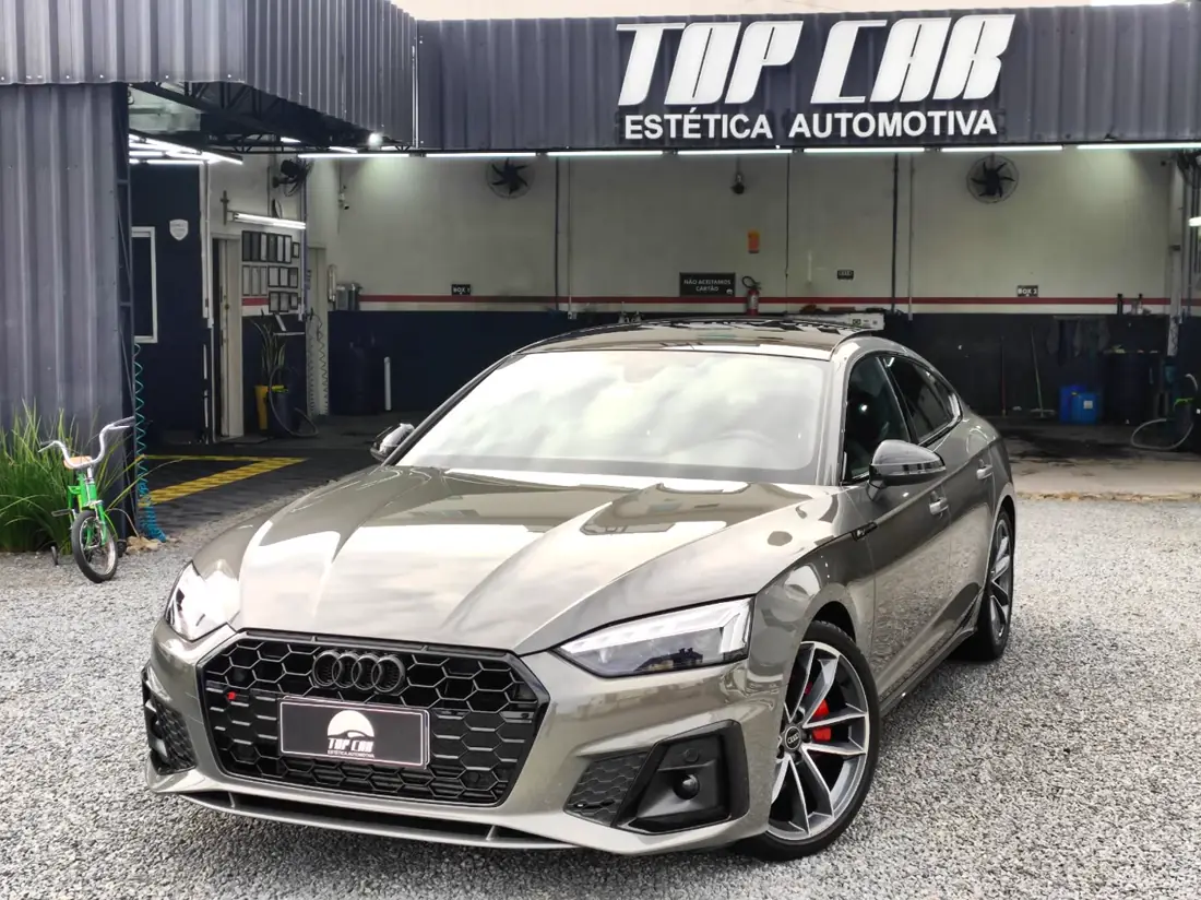 Audi A5 Sportback cinza em frente à fachada da Top Car